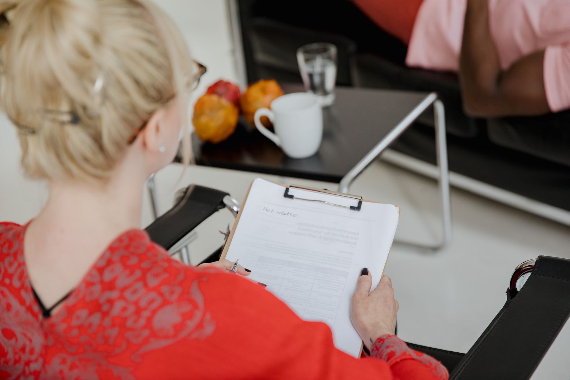 Woman holding clipboard in front of folder