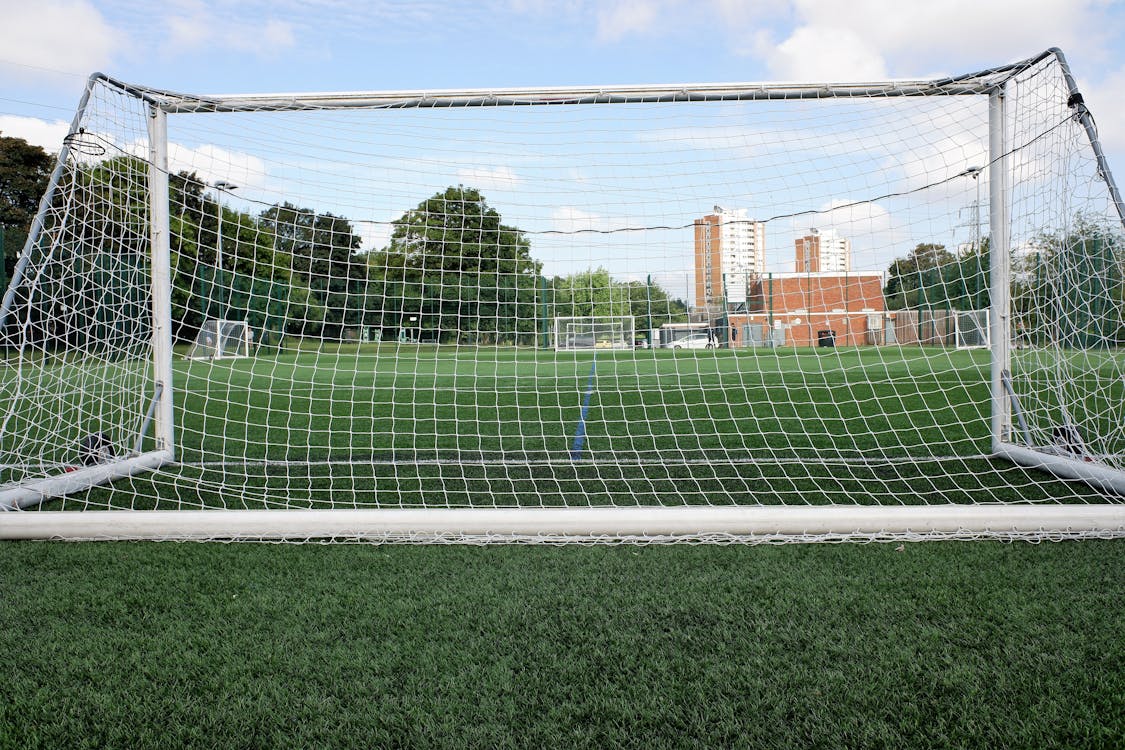 Free Football Net on Green Field Outdoors Stock Photo