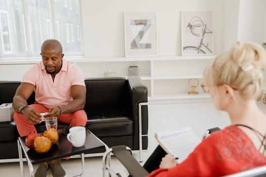 Professional therapy session with diverse clients in a modern setting focusing on mental health support.
