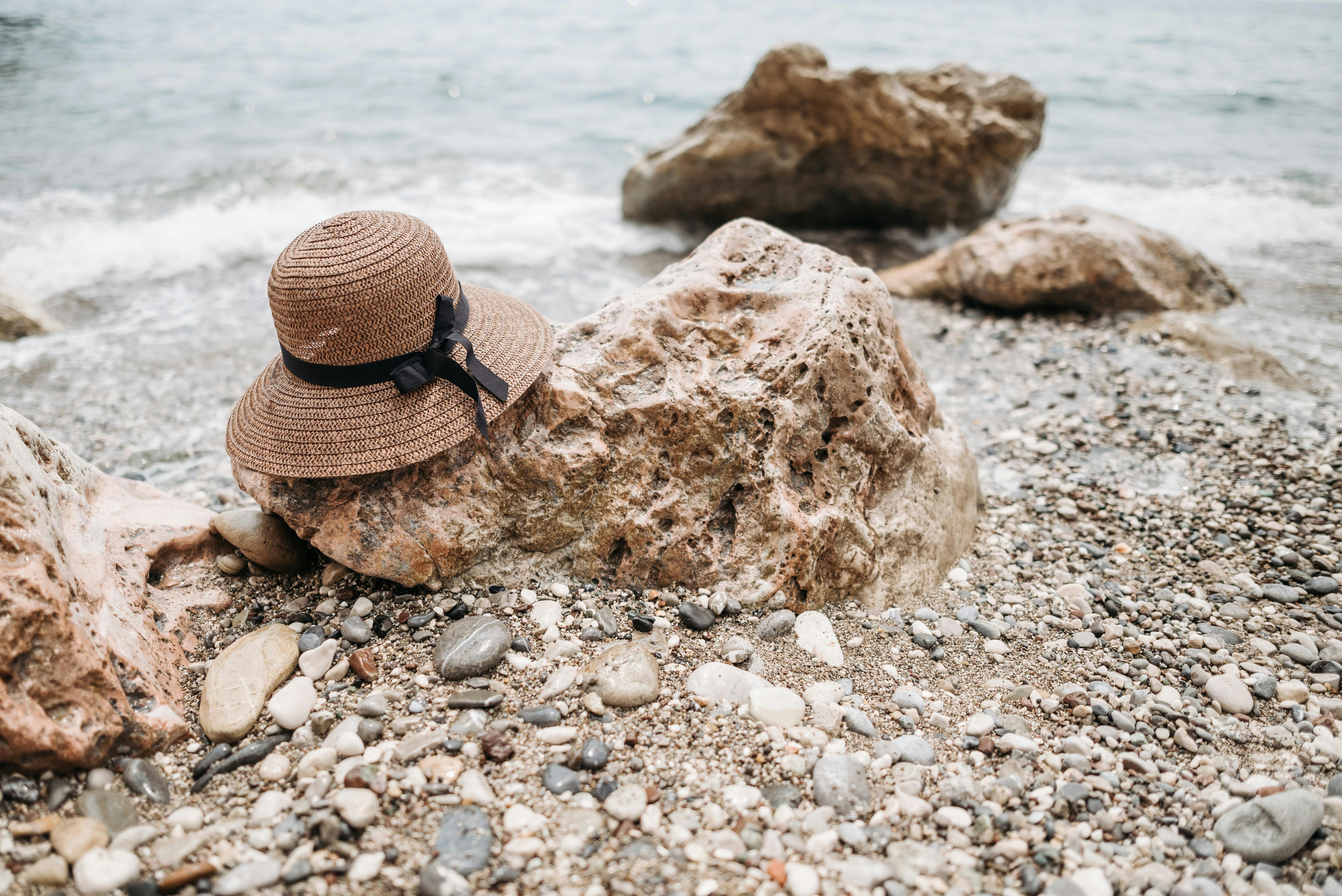 straw hat on beach rocks perfect style for your crochet sun hat pattern