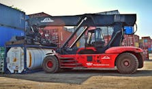 Red and Black Front-loader Beside Intermodal Containers