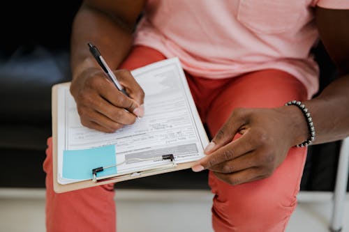 A Person Writing on Paper