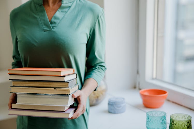 Close-up Of A Person Carrying Books