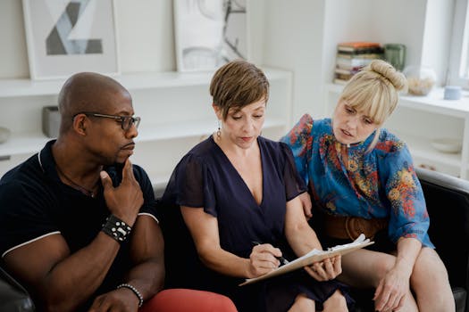 A diverse group meeting indoors, discussing mental health and strategy.
