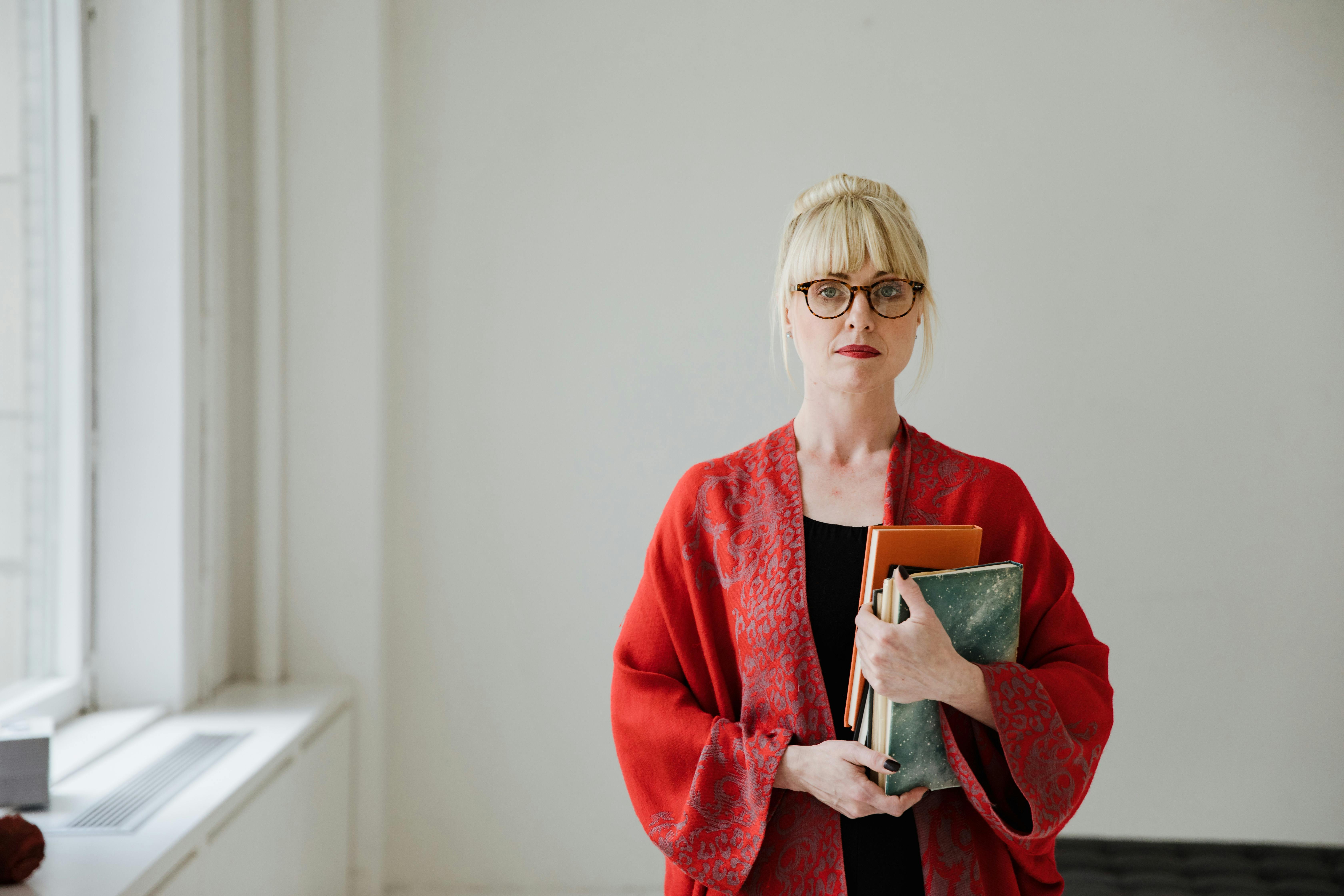 Pretty woman Wearing a Robe Holding Books · Free Stock Photo