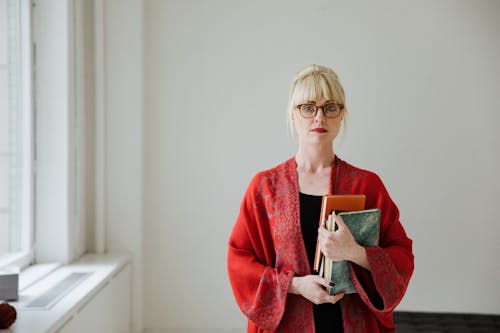 Pretty woman Wearing a Robe Holding Books