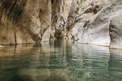 Free Explore the serene waters and towering rock formations of Göynük Canyon in Turkey's beautiful landscape. Stock Photo