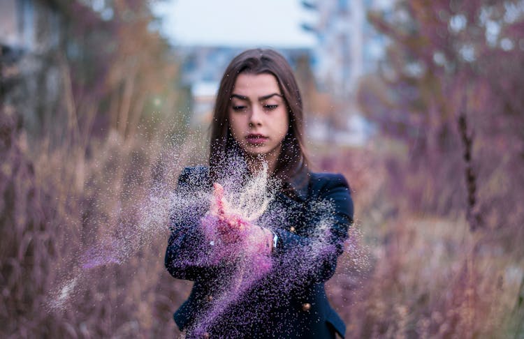 Woman Scattering Glitter Outdoors 