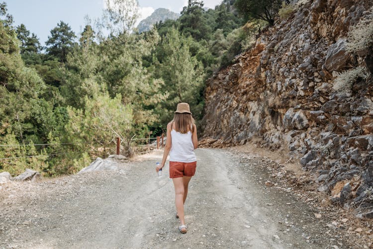 Woman Walking On Mountain Road