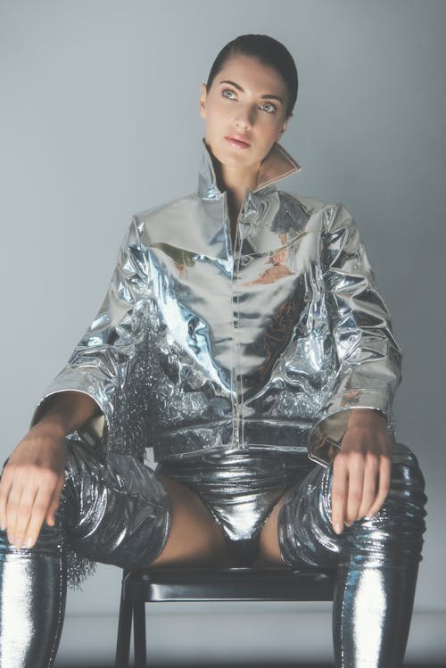 Woman Posing in Silver Metallic Jacket, Panties, and High Boots