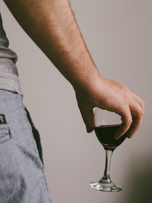 Close-Up Shot of a Person Holding a Glass of Wine