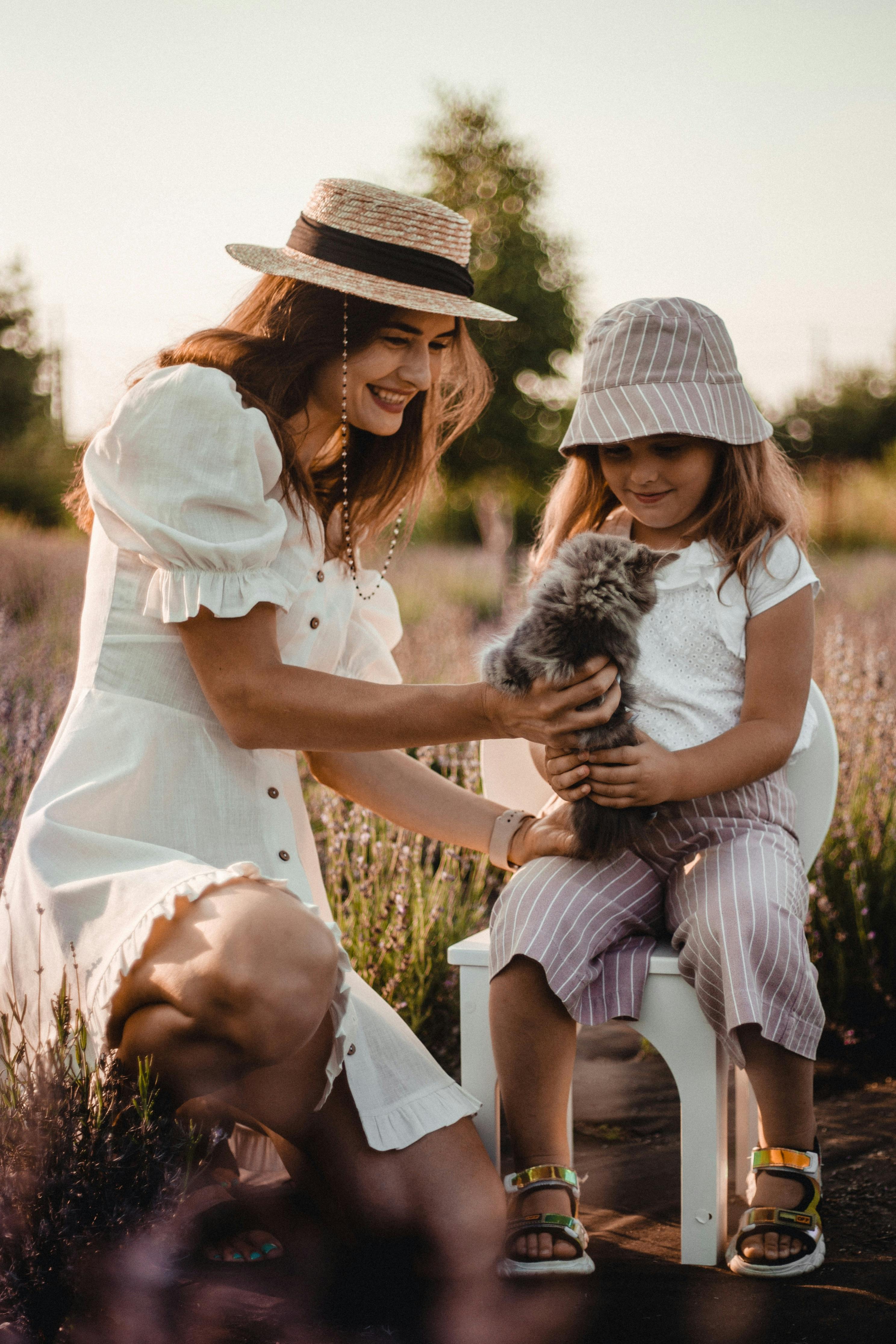 mother and child playing with their cat