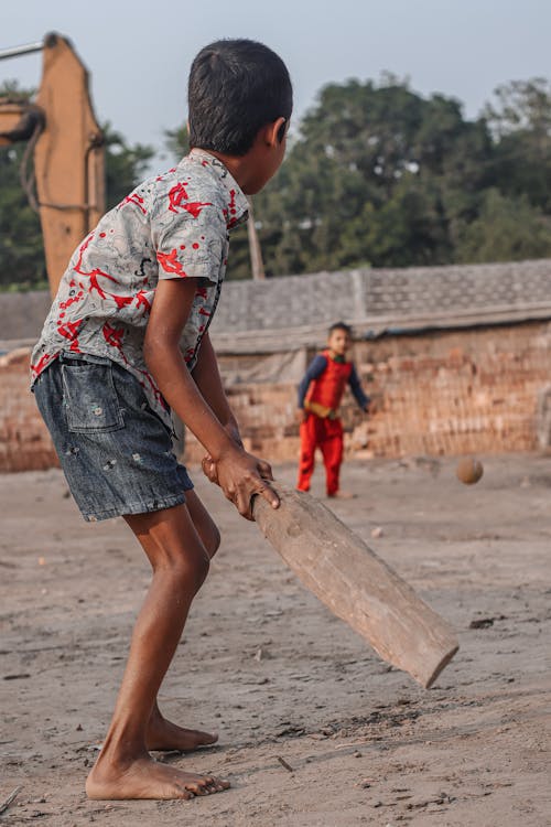 Boys Playing Cricket Barefoot