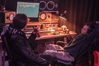 Men Sitting on Chairs Inside a Room Looking at the Monitor