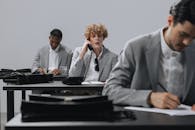 Man in Gray Suit Jacket Talking to Man in Gray Suit