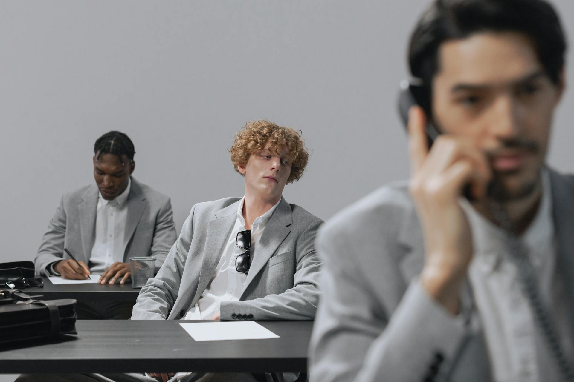 Three Men in Gray Suits Working in the Office