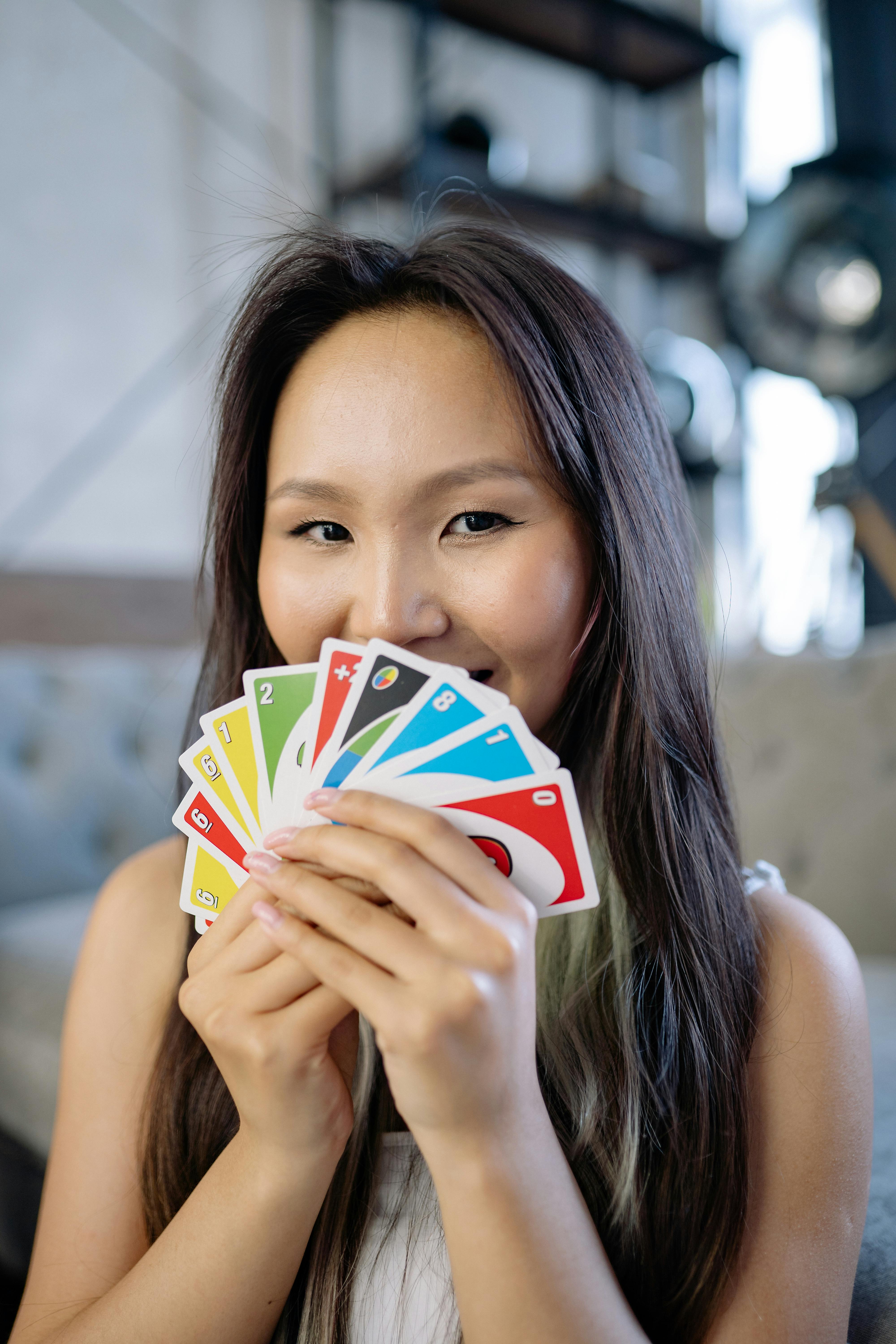 Playing American Card Game Uno, Holding Game Cards in Female Hand