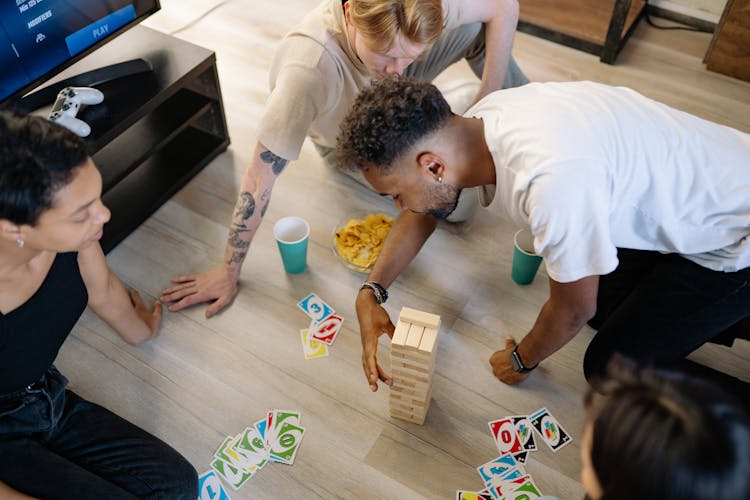 Friends Playing Jenga And Uno 