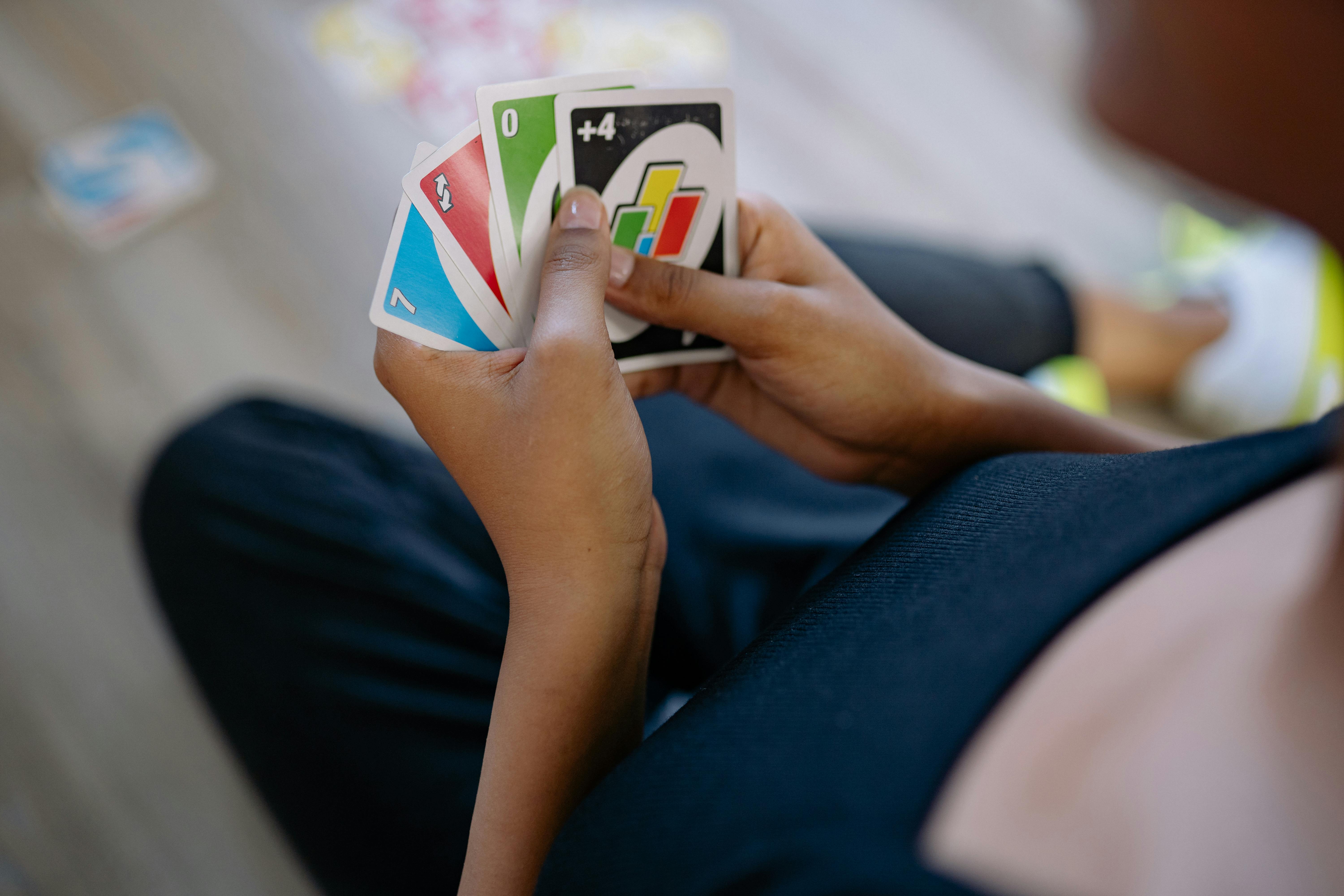 Playing American Card Game Uno, Holding Game Cards in Female Hand