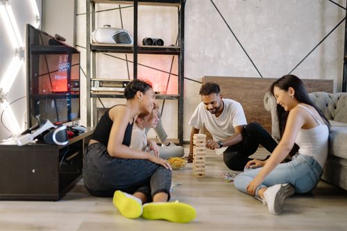 Free A group of diverse friends playing games and having fun indoors. Stock Photo