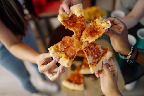 Free People Holding Pizza Slices  Stock Photo