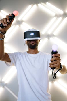 An adult man immersed in a virtual reality game using VR headset and controllers.