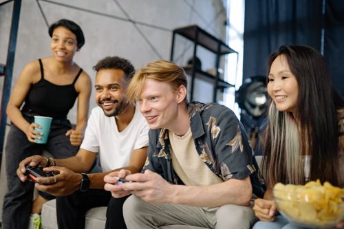 Free Diverse group of friends having fun gaming together in a cozy indoor setting. Stock Photo