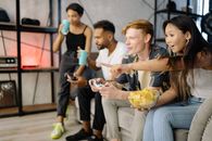 Woman in Black Tank Top and Blue Denim Jeans Holding White Ceramic Bowl