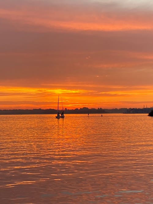 Silhouette of Boats on the Sea during Sunset