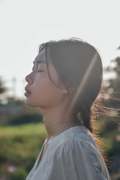 Woman Wearing White Blouse with Eyes Closed