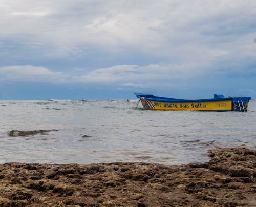 A Blue and Yellow Boat on the Sea