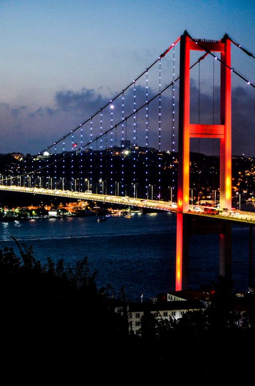 Free Dramatic night view of İstanbul's Bosphorus Bridge illuminated with vibrant lights. Stock Photo