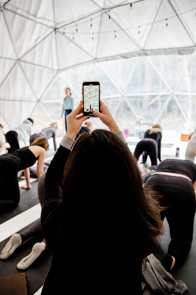 Person Taking Picture Of A Yoga Class