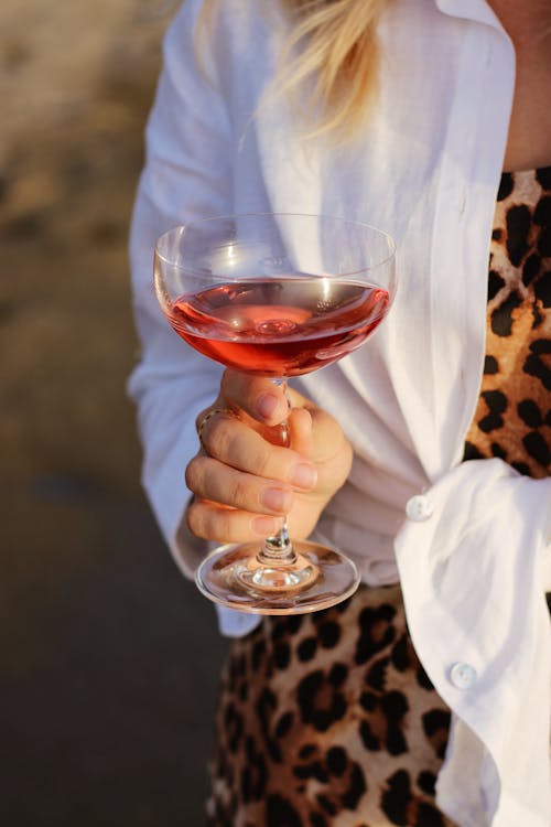 A Person Holding Clear Wine Glass With Red Wine