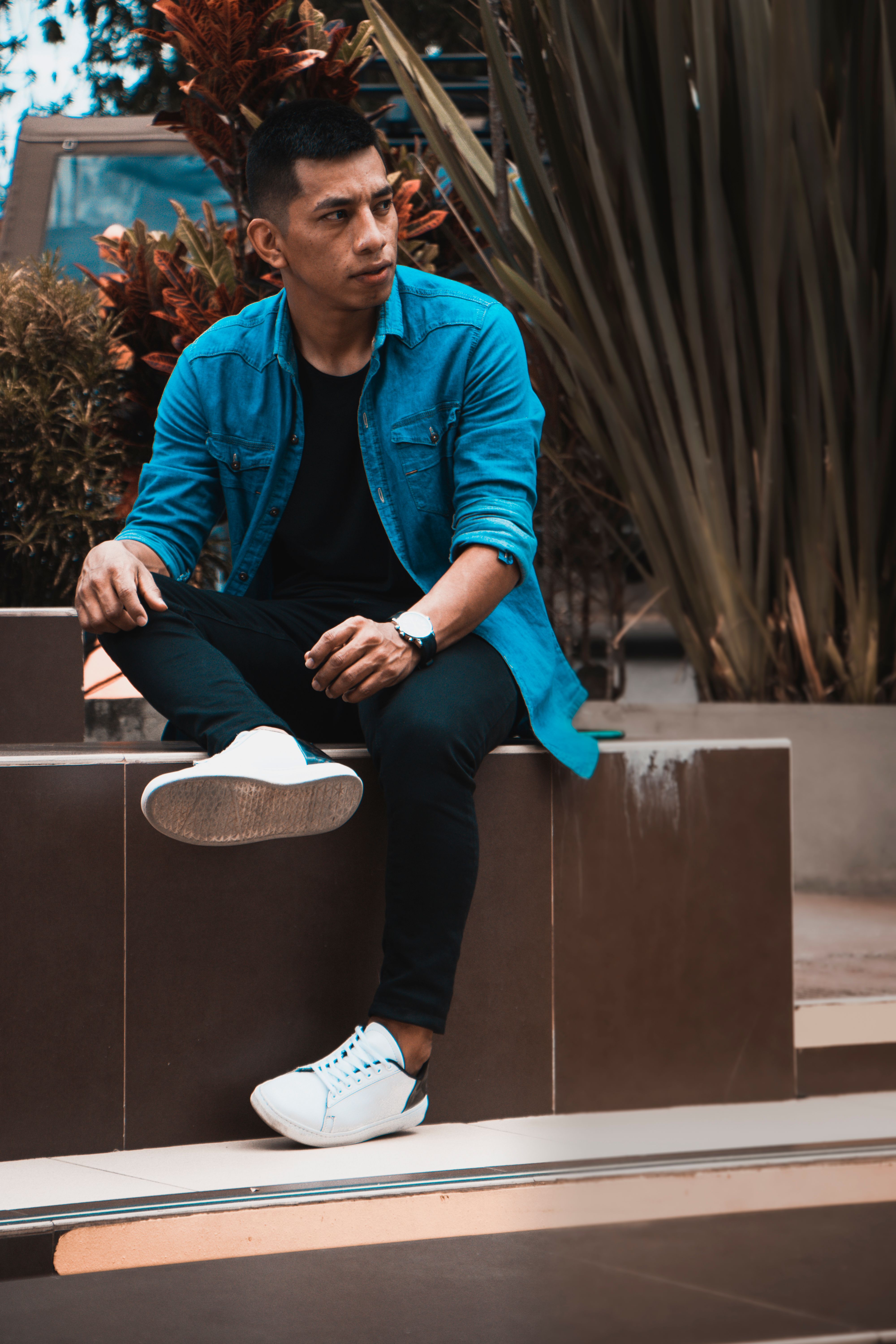 A Man in Plaid Pants and Top Sitting 