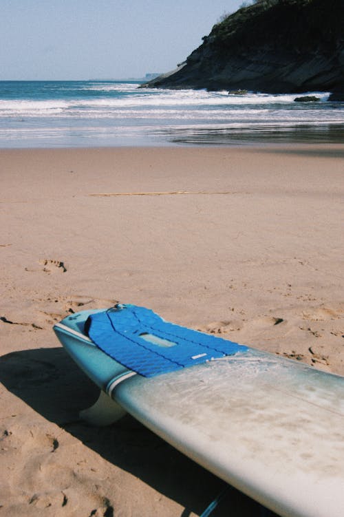Blue Surfboard on the Beach