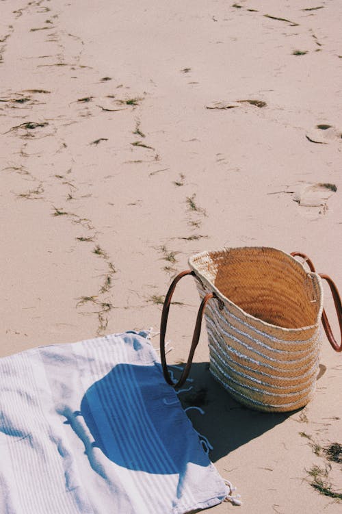 Woven Bag and Towel on White Sand