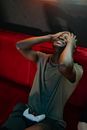 Man in Gray Crew Neck T-shirt Sitting on Red Couch