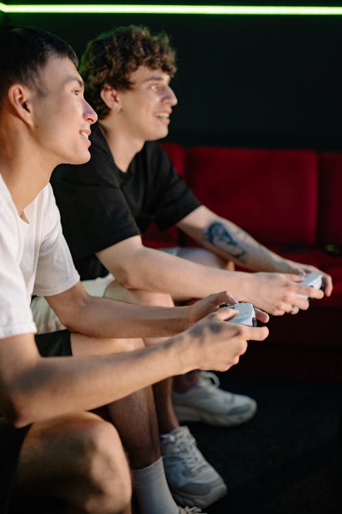 Two Men Holding Game Controllers