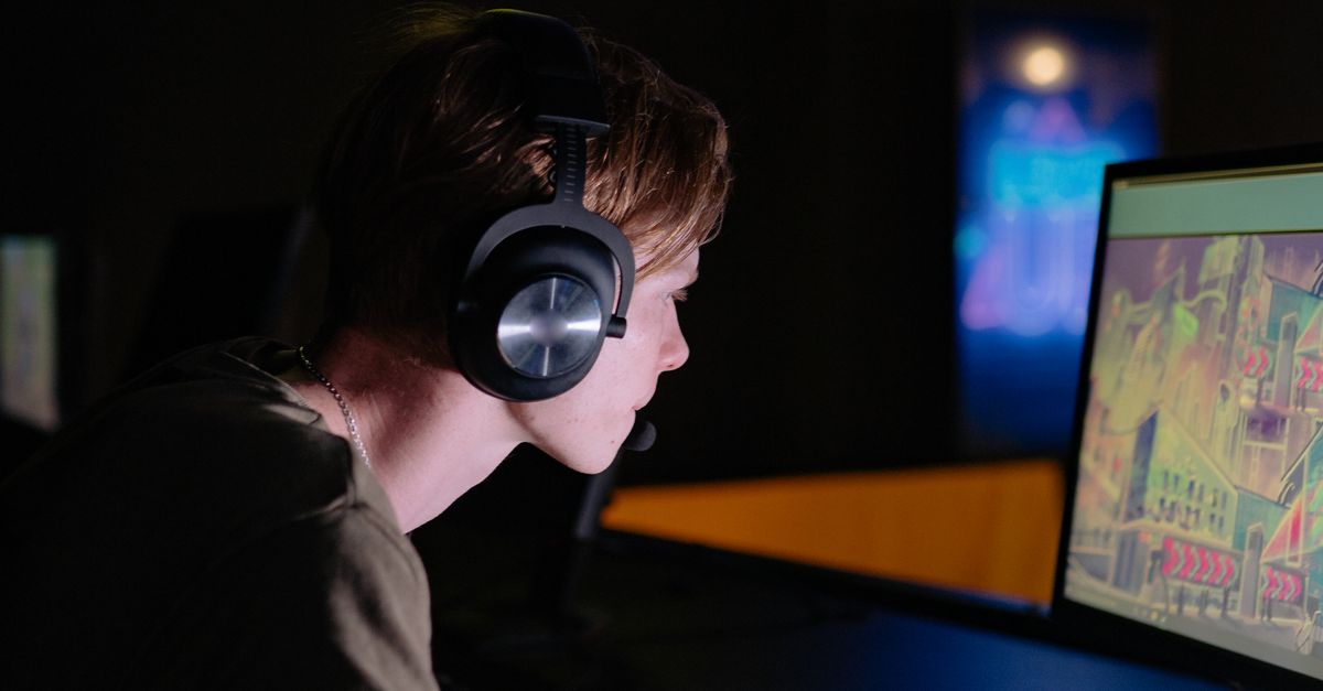 A Man Playing a Video Game in a Computer · Free Stock Photo