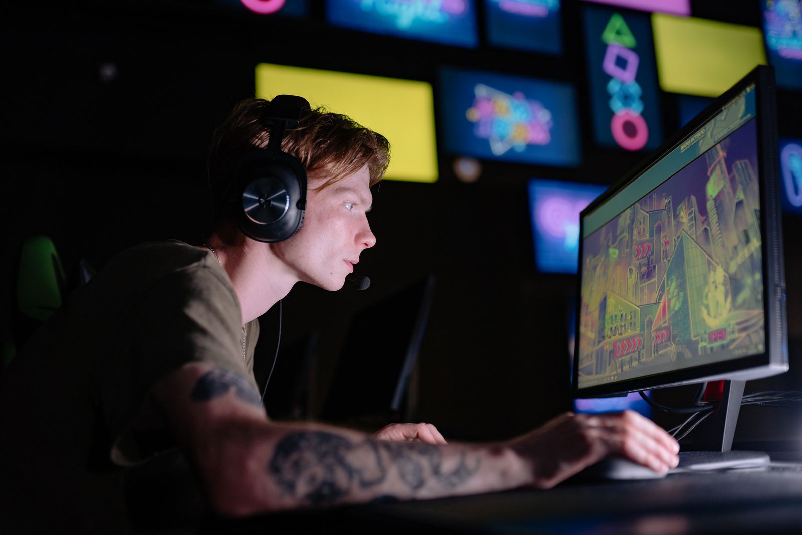 Gamer wearing headphones while using a computer gaming station