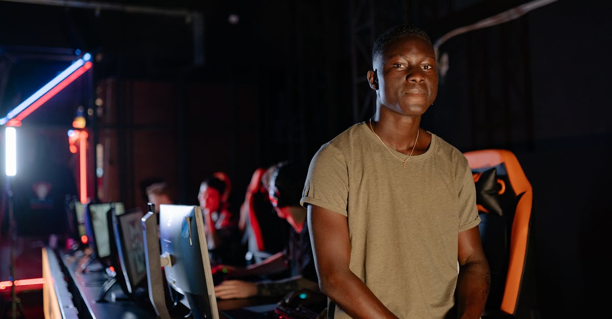 Man in Brown Crew Neck T-shirt Sitting on the Edge of the Gaming Table
