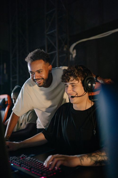 Free Two young men enjoying an intense esports tournament indoors. Stock Photo