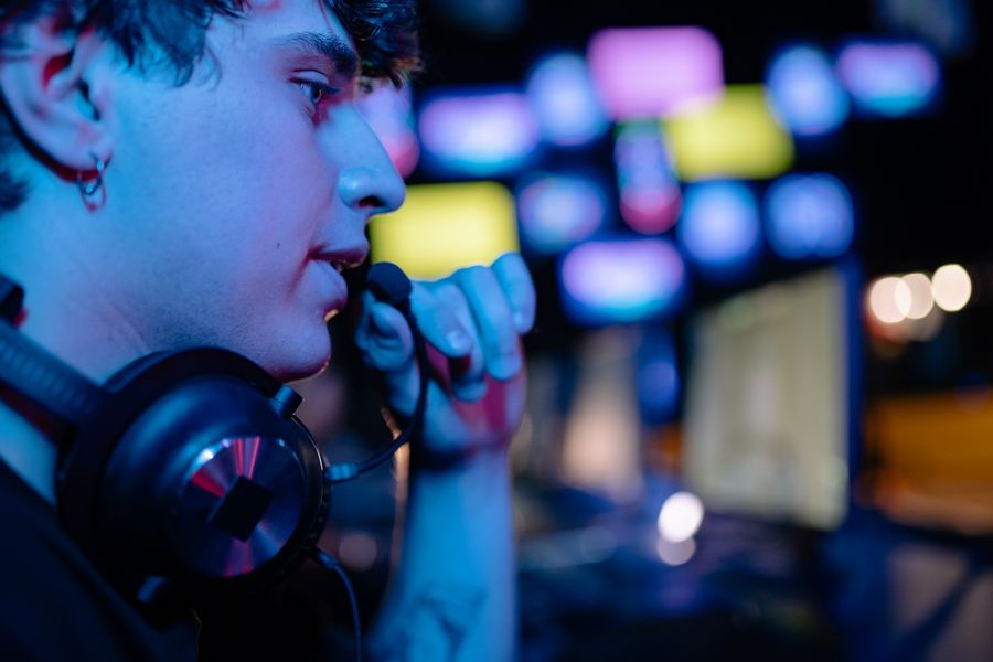 Streamer wearing a headset under neon light — photo by Yan Krukau on Pexels