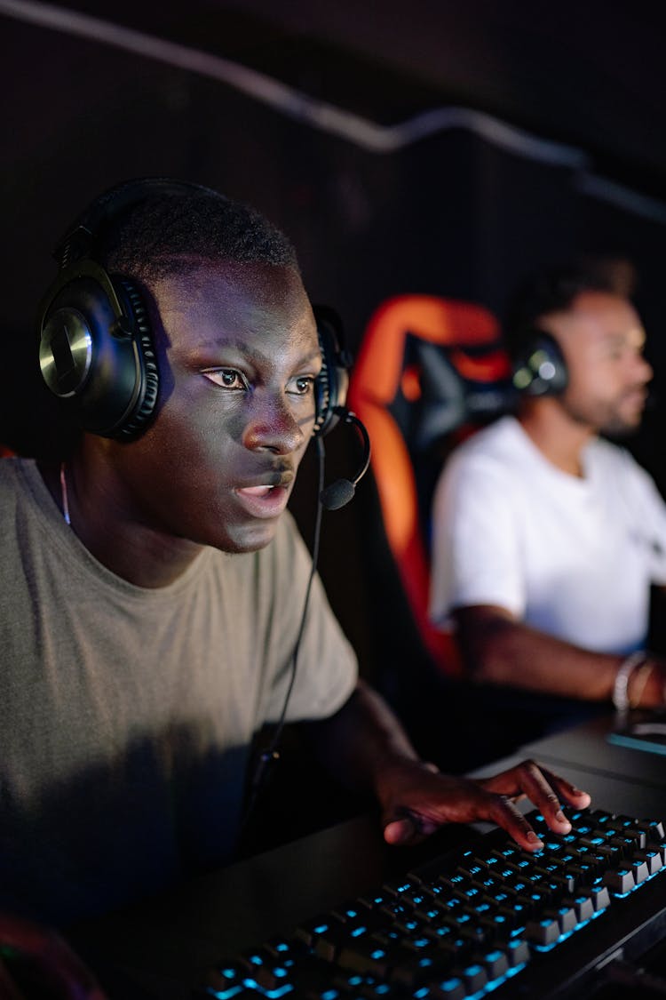 Photo Of A Focused Man Playing On A Computer