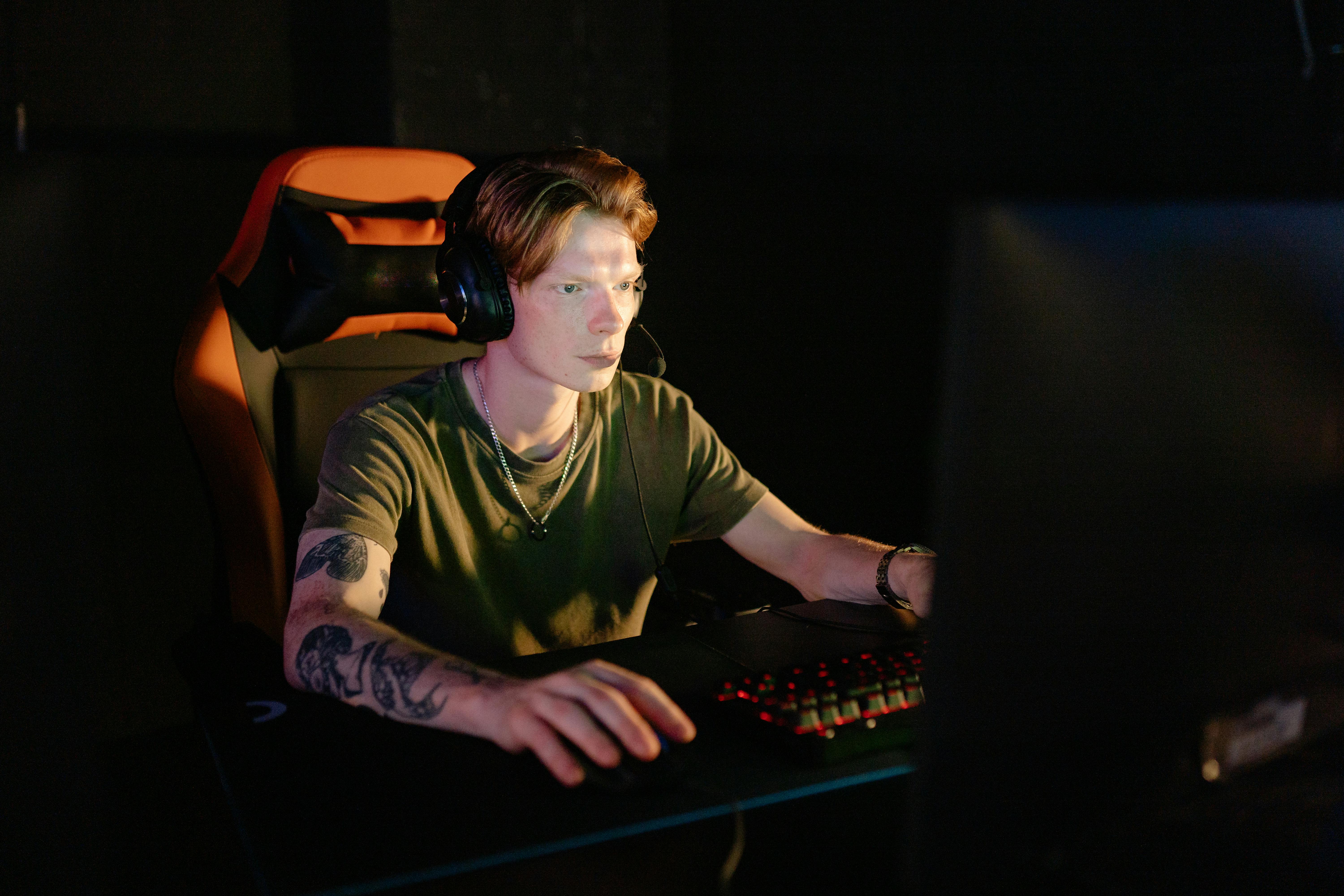 a man in green crew neck t shirt playing computer games