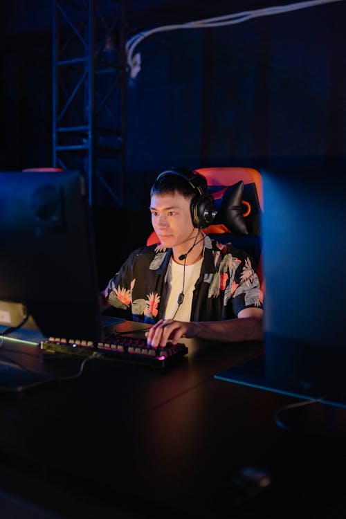 Man in a Floral Shirt Playing on a Computer