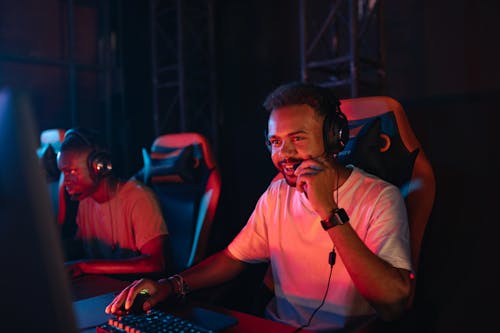 Free Photo of a Man in a White Shirt Holding the Microphone of His Headset Stock Photo