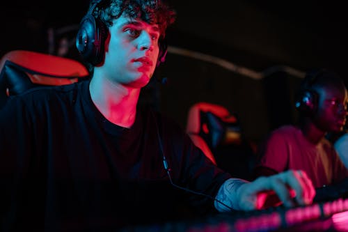 Low-Angle Shot of a Man in a Black Shirt Playing on a Computer