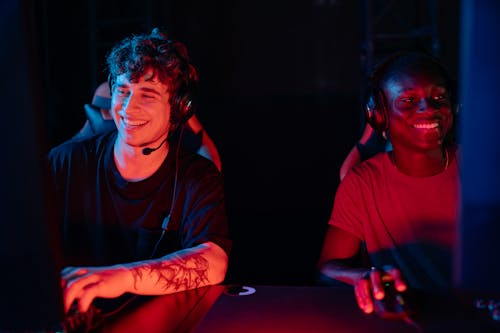 Smiling Players Sitting at Computers